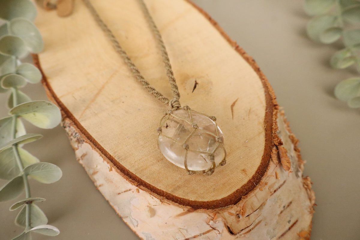 Handgemaakte macramé ketting met heldere bergkristal en ster in een geknoopt netje op lichtgroen koord